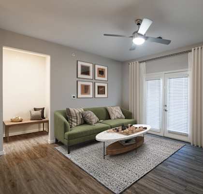 A living room with a green couch and a coffee table.