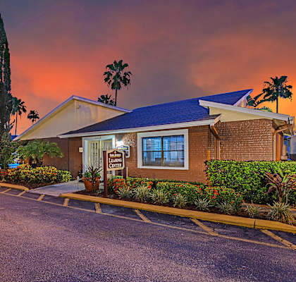 Park Avenue Apartments Tampa Florida Clubhouse Entrance with Glowing Orange Sunset in Background
