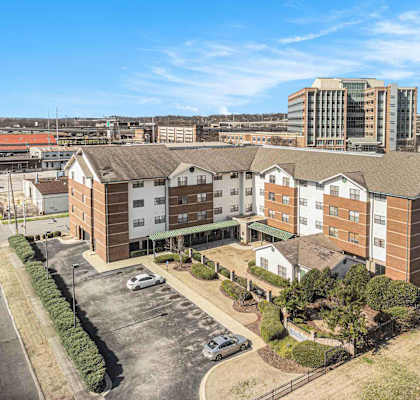 an aerial view of an apartment complex with a city in the background