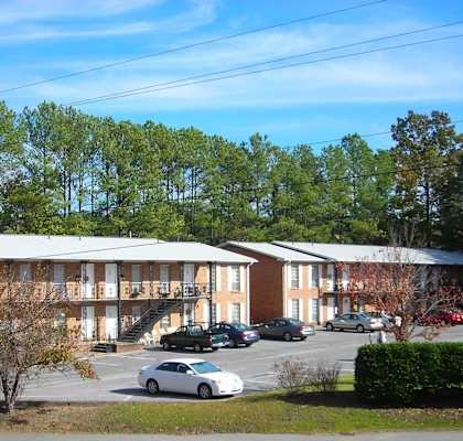 A large building with a parking lot in front of it.