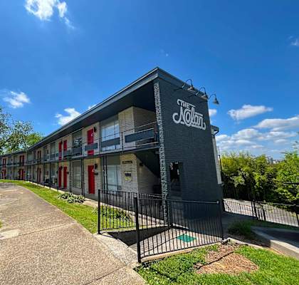 The Kolam building has a black fence and red doors.