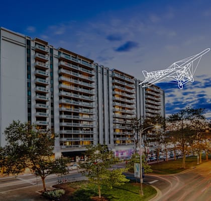 an aerial view of an apartment building with a crane on top of it