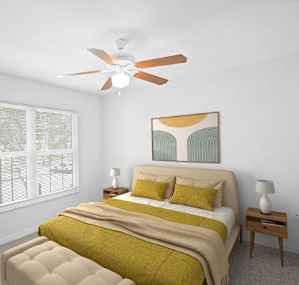 A bedroom with a bed, nightstand, and a plant.