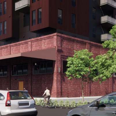 A red building with a balcony on the second floor.