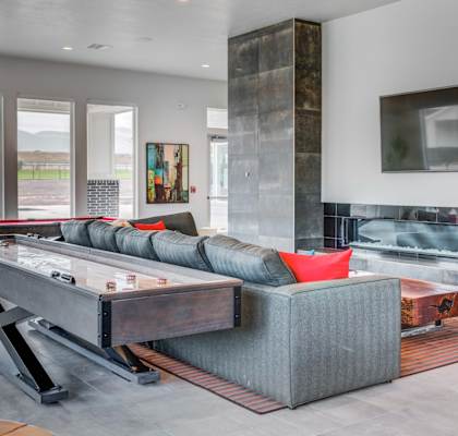 the living room has a shuffleboard table and a pool table at Affinity 56  apartments in West Jordan, UT