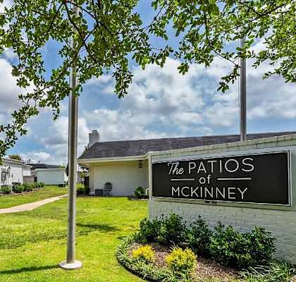 a sign for the patios in front of some houses