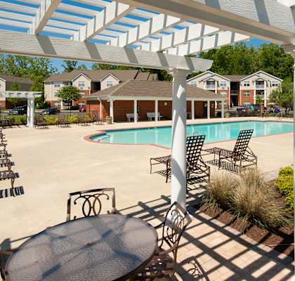 Pool With Cabanas and Chairs