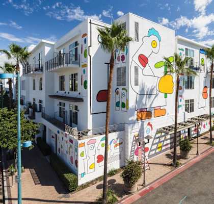 a building with a mural on it on the side of a street