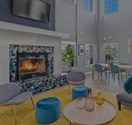 A living room with a fireplace and a TV mounted on the wall.