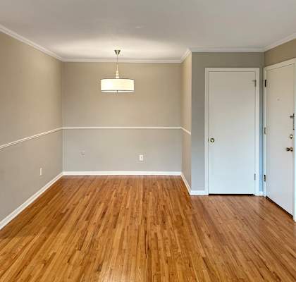 A room with wooden floors and white walls.