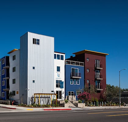 a group of modern buildings with a blue sky behind them at Legacy Apartments, 91325