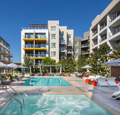 a rendering of a pool in front of an apartment building