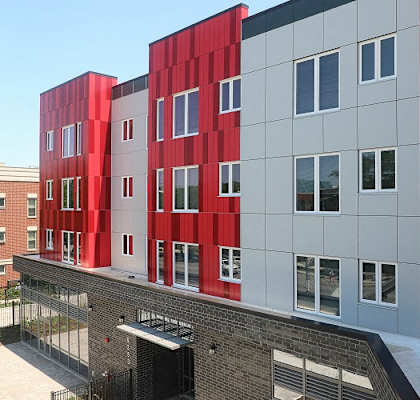 a red and white building with windows and a roof