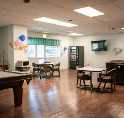a recreation room with a pool table and ping pong table