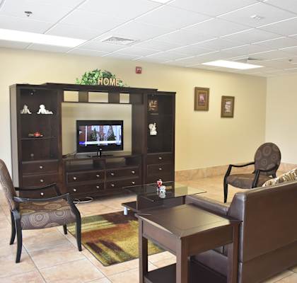 a living room with a television and a table and chairs
