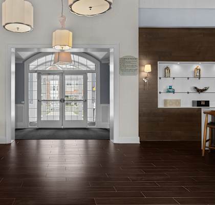 A room with a wooden floor and a large glass door.