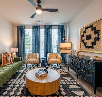 a living room with a green couch and a coffee table