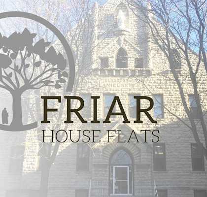 A building with the words Friar House Flats in front of it.