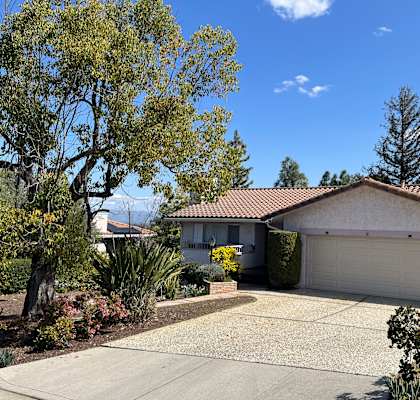 A house with a brown roof and a white garage door.