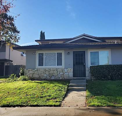 4795 Capay Drive, #1, San Jose, CA 95124
 A house with a grey front yard and a black door.