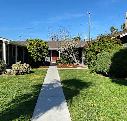a sidewalk in front of a house