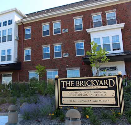 Front of the Brickyard Apartments with sign.