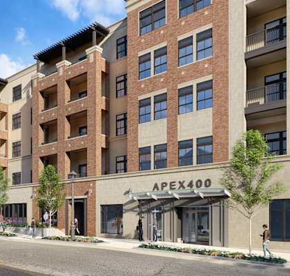 a rendering of a large apartment building on a city street