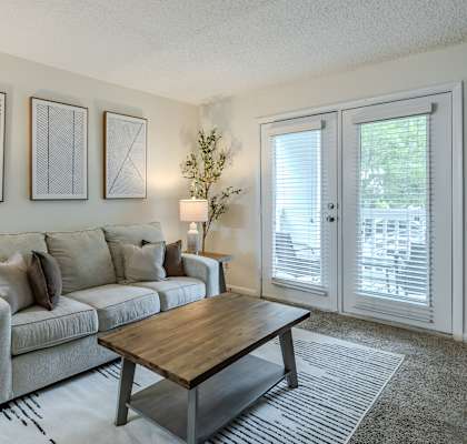 the living room of an apartment with a couch and a coffee table