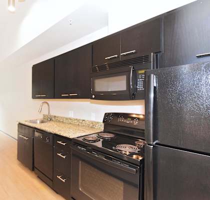 kitchen in a bedroom plus den unit.