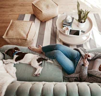 stock image- woman on couch with pet