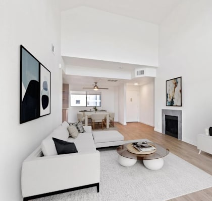A modern living room with a white couch and a coffee table.