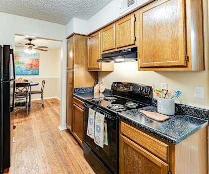 a kitchen with wood cabinets and black appliances