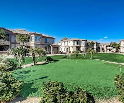A golf course surrounded by residential buildings.