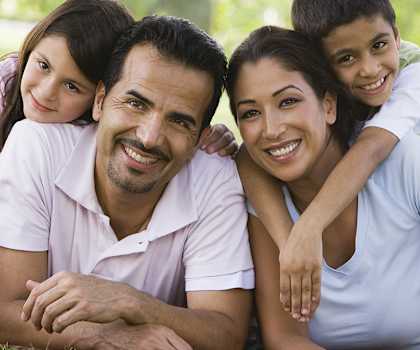 A family of four is enjoying a picnic in a park.