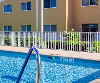 Sparkling pool at Villa Seton beside apartment buildings