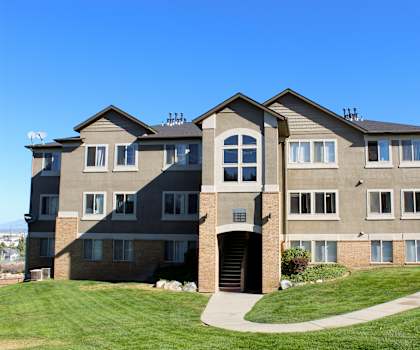 an image of an apartment building with a green lawn
