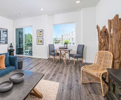 a living room with white walls and hardwood floors
