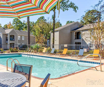 our apartments have a swimming pool with chairs and umbrellas