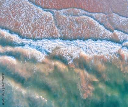 a close up of the waves at the beach
