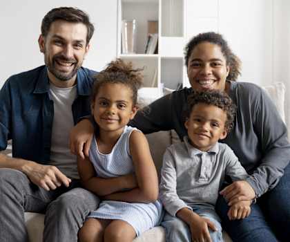 a happy family sitting on a couch