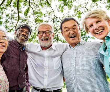 a group of seniors standing next to each other laughing