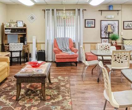 Lobby with sofa, chairs and tables, large windows, and overhead lighting at Casa San Pablo