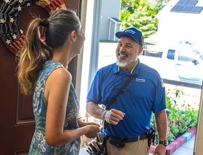 A man in a blue shirt is talking to a woman in a blue dress.