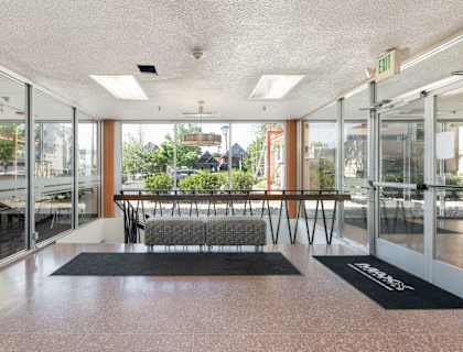 a lobby with a couch and a table in the middle