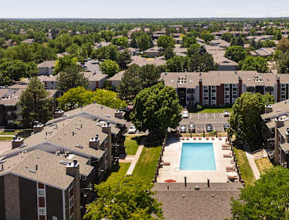an aerial view of an apartment complex with a swimming pool