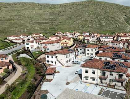 A small town with a lot of buildings and solar panels on the roofs.