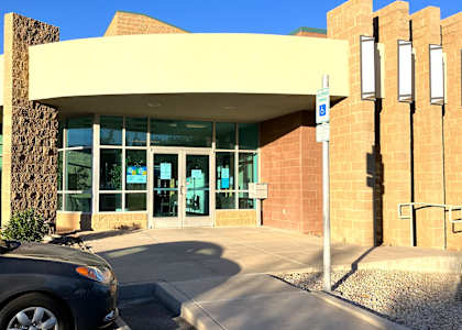 A building with a car parked in front of it.