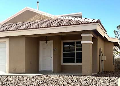 A house with a brown roof and a white garage door.