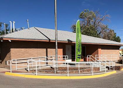 A building with a green sign that says "Tenant Parking Only" in front of it.