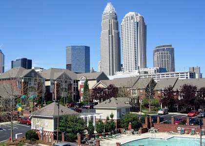 A cityscape with tall buildings and a swimming pool in the foreground.